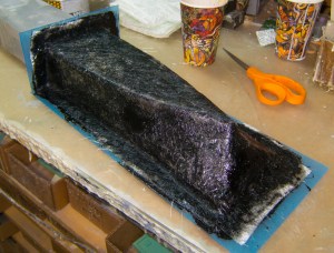 Fiberglass mat applied over gel coat